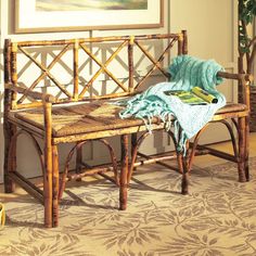 a wooden bench sitting on top of a carpeted floor next to a potted plant