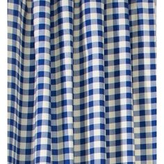 a blue and white checkered curtain hanging on a window