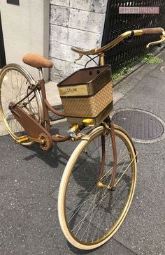 an old bicycle with a basket is parked on the street