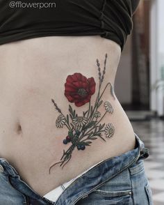 a close up of a woman's stomach with flowers on it