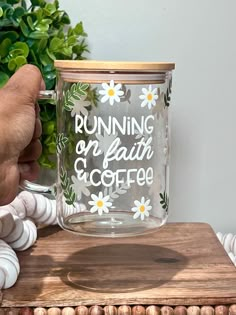 a person is holding a coffee mug with the words running on faith and coffee