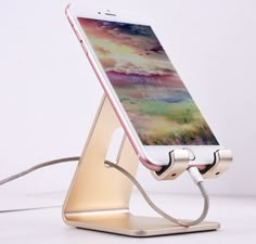 an iphone charging on a charger in the shape of a stand with a phone attached to it