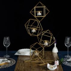 a table topped with candles and plates on top of a wooden table