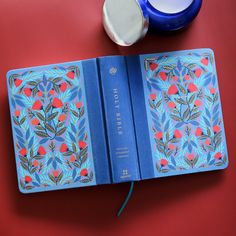 an open blue book sitting on top of a red table