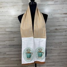 a brown and white checkered scarf with coffee mugs on it