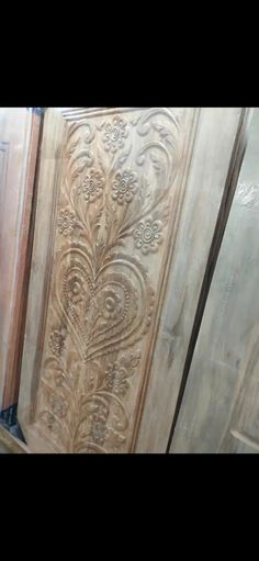 two doors with decorative carvings on them in a room that is being remodeled and painted