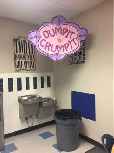 a restroom with two urinals and a sign that says dump it to crump