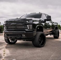 a large black truck parked in a parking lot