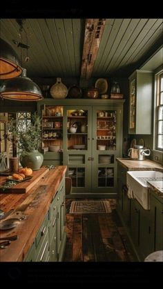 an old fashioned kitchen with green cabinets and wood flooring is pictured in this image