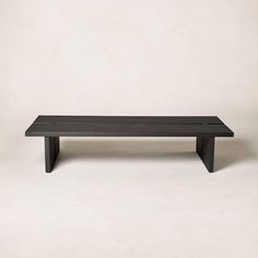 a black bench sitting on top of a white floor