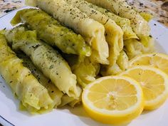 some pasta and lemon slices on a white plate