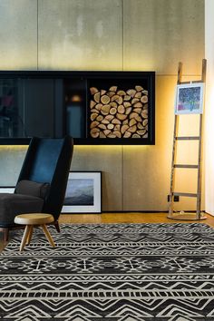 a living room with zebra print rug, ladder and firewood logs in the fireplace