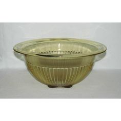 a gold glass bowl sitting on top of a white table