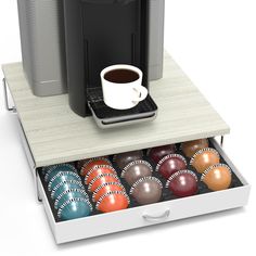 a coffee maker and some balls in a drawer