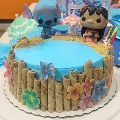 a birthday cake decorated with sand and flowers