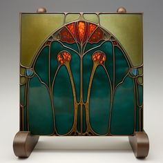 an art nouveau stained glass panel with two flowers on the front and sides, set against a white background