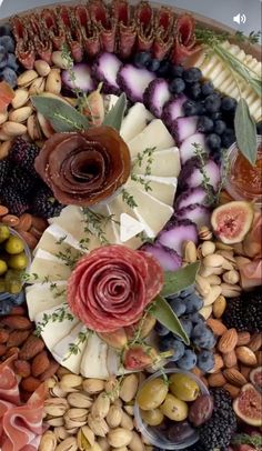 a platter filled with different types of fruits and veggies on top of each other