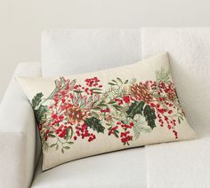 a white couch with a christmas pillow on it