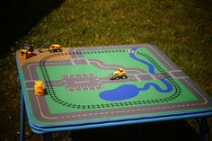 a toy table with cars and trucks on it