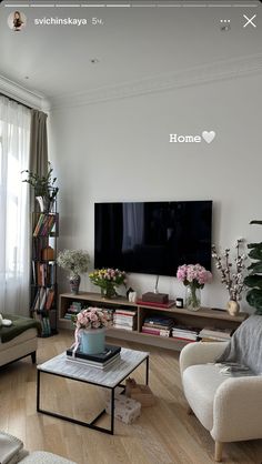 a living room filled with furniture and a flat screen tv mounted on a wall above a wooden coffee table