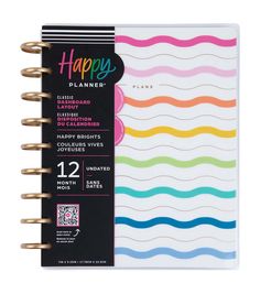 a spiral notebook with rainbows on the cover and happy planner written in black ink