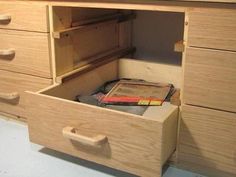 the drawers are open and there is a book in one drawer on the other side