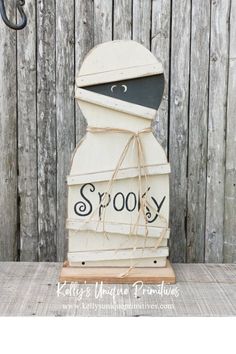 a wooden sign that says spooky on it