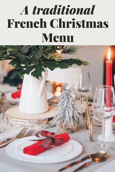 a table set for christmas dinner with red napkins, silverware and white plates