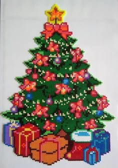 a cross stitch christmas tree with presents on it