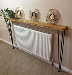 a radiator and some plants on a shelf