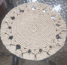 a round rug with tassels on top of it