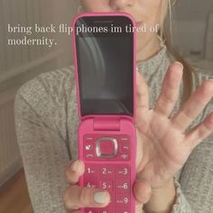 a woman holding up a pink cell phone in front of her face with the text bring back flip phones i'm tired of modernity