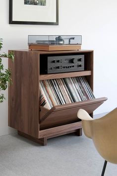 an old record player sitting on top of a wooden cabinet