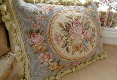 a close up of a pillow with flowers on it