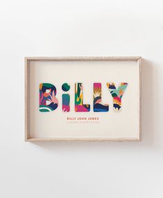 the word billy is made up of cut out pieces of paper in a shadow box