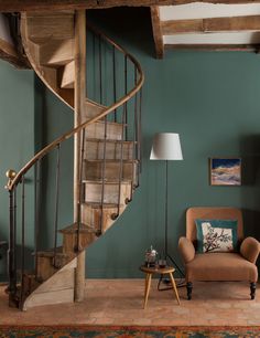 a living room filled with furniture and a spiral staircase