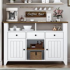 a coffee bar with white cabinets and shelves