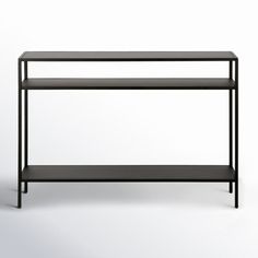 a black shelf sitting on top of a white wall