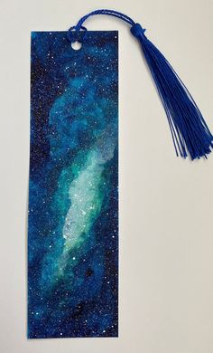 a bookmark with a blue tassel hanging from it