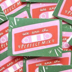 there is a pile of pink and green stickers that say we are the perfect mix