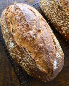 two loaves of bread sitting on top of a cooling rack