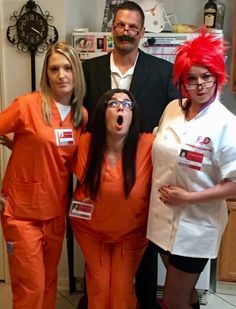 four people dressed in orange and white posing for a photo with their mouths wide open