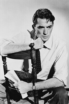 black and white photograph of a man sitting in a chair