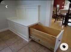 a white bench sitting on top of a wooden floor