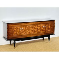 a large wooden cabinet sitting on top of a hard wood floor next to a wall