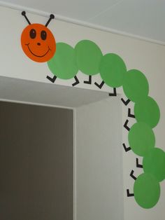 the very hungry caterpillar on the wall is ready to be cut in half