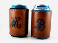 two leather can coolers with monogrammed letters on them