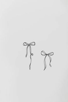 two black and white bows tied to each other on a light gray background with copy space