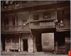 an old black and white photo of a building with balconies on the balcony