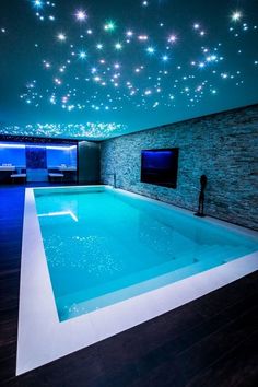 an indoor swimming pool with stars on the ceiling